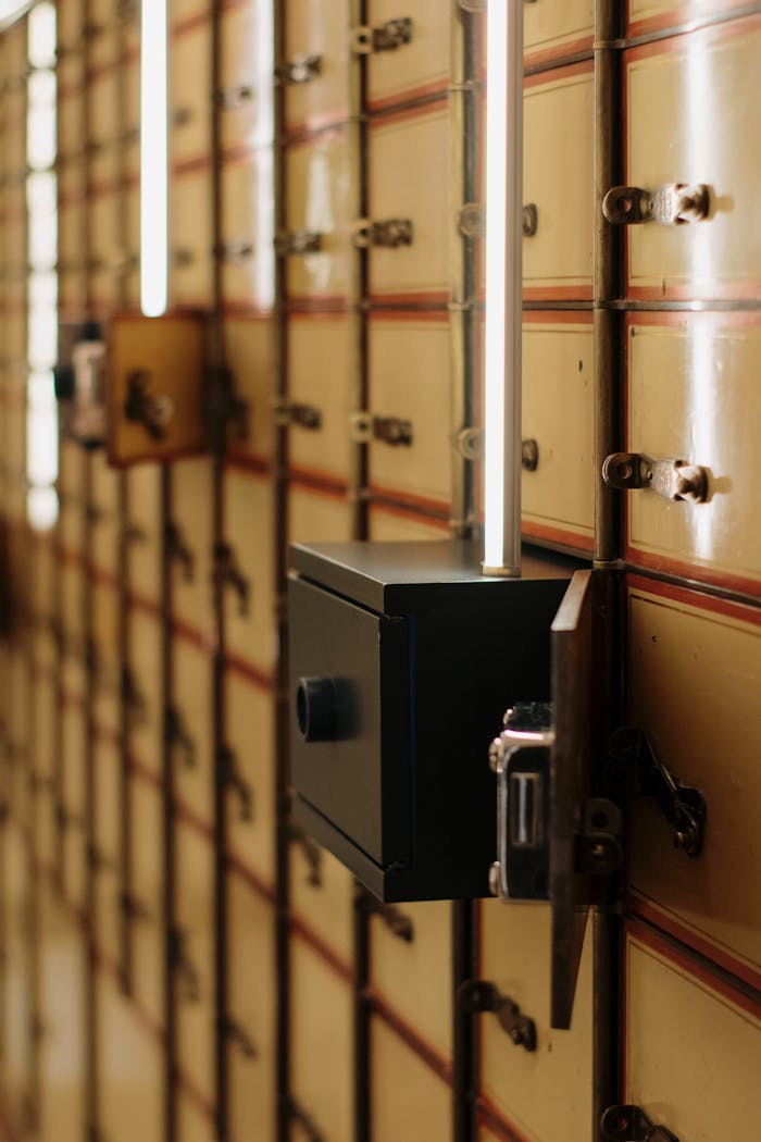 about-02 Close-up of vintage safety deposit boxes with one open, revealing secure interiors.