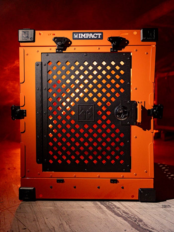 Sturdy orange and black dog crate designed for pet safety and durability. Ideal for home lifestyles.